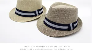 Detailed macro view of woven straw fedora hats with stylish striped ribbon decorative band