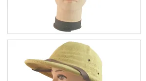 Detail of woven straw sun hat with brown leather strap and metal eyelets on model