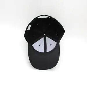 Interior view of black cotton baseball cap showing reinforcement and adjustable metal strap