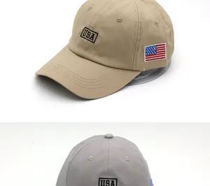 Detailed close-up of khaki and grey USA baseball caps with flag embroidery on the side