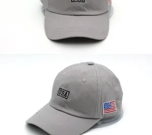 Detail of USA embroidery and American flag patch on the gray cotton baseball cap