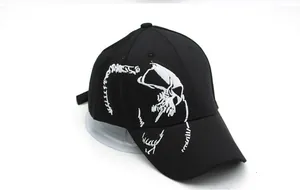 Close-up of intricate white skull bone embroidery on the black cotton baseball cap