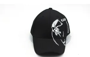 Detailed close-up of white abstract skull embroidery on a black cotton baseball cap