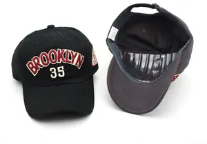 Close-up of black cotton baseball cap with red Brooklyn 35 embroidery and inner lining