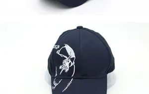 Close-up of white skull embroidery on navy blue cotton twill baseball cap