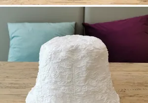 Close-up detail of white bubble crinkle fabric on a minimalist women's bucket hat
