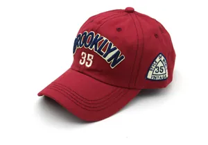Detailed embroidery of Brooklyn and vintage patches on red cotton baseball cap