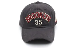 Close-up of BROOKLYN 35 3D embroidery on charcoal gray washed cotton baseball cap