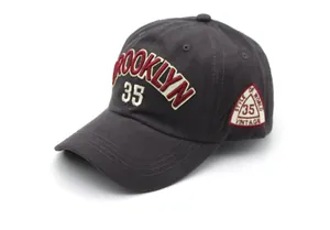 Detailed close-up of charcoal cotton baseball cap with Brooklyn 35 3D embroidery and vintage patch
