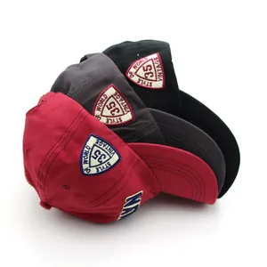 Three Brooklyn style cotton baseball caps in red, grey, and black with vintage embroidery