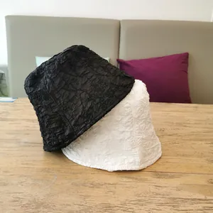 Women's seersucker bucket hats in black and white with pleated texture for sun protection