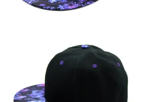 Close-up showing galaxy nebula print on peak and purple eyelets of black snapback cap