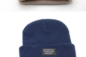 Detailed close-up of navy and beige knit beanies with stylish embroidered text patches