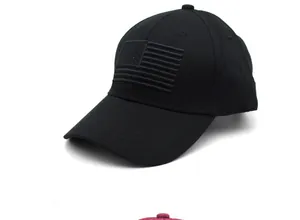 Close-up of tonal American flag embroidery on a black cotton twill baseball cap