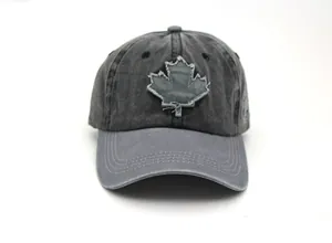 Close-up of vintage washed cotton baseball cap featuring embroidered maple leaf patch