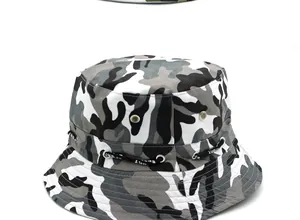 Detail of camouflage boonie hat featuring side metal eyelets and a black SPORT ribbon strap