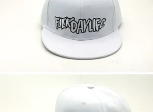 Detail of white snapback hat with black graffiti FUCKDAYLIFE embroidery and canvas texture