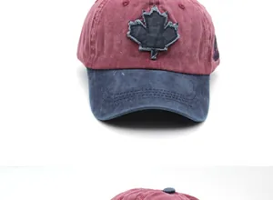 Detail of burgundy washed cotton baseball cap with navy brim and maple leaf patch