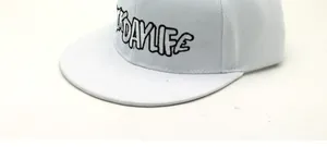 Detail shot of white snapback hat with DAYLIFE 3D embroidery and twill cotton fabric