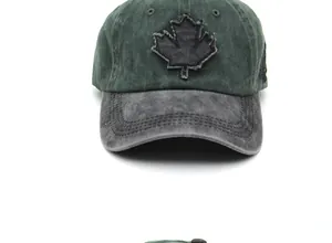Detail of embroidered maple leaf patch on olive green washed cotton baseball cap