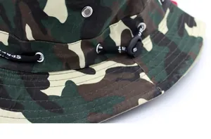 Detailed macro of jungle camo bucket hat with metal eyelets and SPORT drawstring