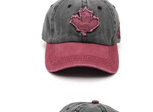 Detailed embroidery of red maple leaf patch on washed cotton baseball cap with ventilation