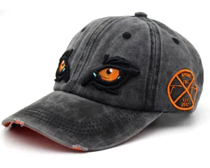 Close-up of distressed charcoal baseball cap featuring eagle eye embroidery and side badge