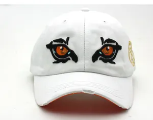 Detailed close-up of tiger eye embroidery and distressed brim on white cotton baseball cap