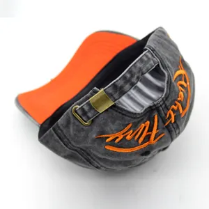 Washed dark gray baseball cap with orange embroidery and copper buckle on the back