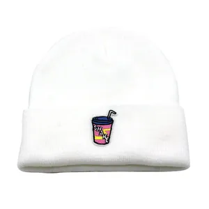 White knitted beanie with milk shake embroidery and SHAKE text in a minimalist style