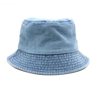 Detail of light blue washed denim bucket hat showing metal eyelets and parallel stitching