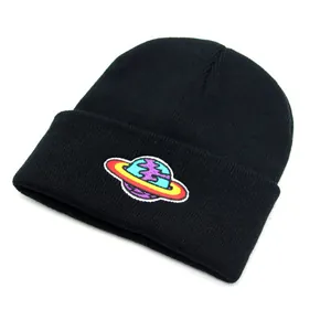 Detail of colorful planet embroidery on black knit beanie for winter street style wear