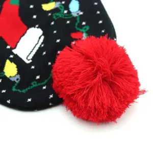 Black Christmas knit hat with festive sock pattern and large red pom-pom decoration