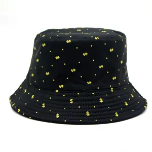 Close-up of black bucket hat fabric with yellow dollar signs and fine stitching detail