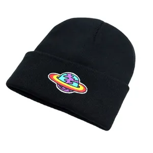 Black beanie featuring colorful planet embroidery patch in a cozy knit fabric