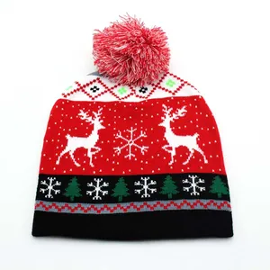 Close-up of a Christmas knitted hat with white reindeer and snowflake jacquard patterns