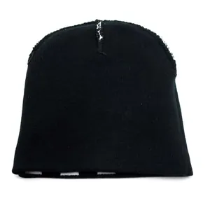 Close-up of black knitted beanie showing white stitch detail and striped inner lining