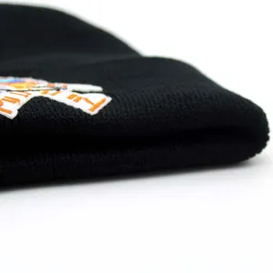 Black ribbed knit beanie with colorful astronaut embroidery patch for winter warmth