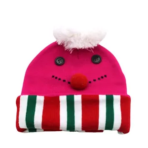 Kids pink Christmas knitted hat with festive cartoon face and white pom-pom on top