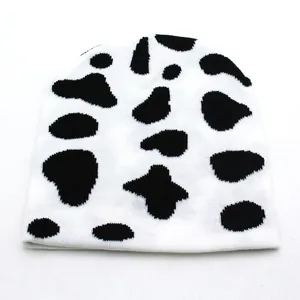 Winter checkered knit beanie featuring black and white cow pattern for men and women