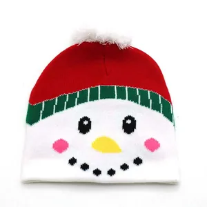 Detail of knitted snowman hat featuring festive red and white colors with a soft pompom