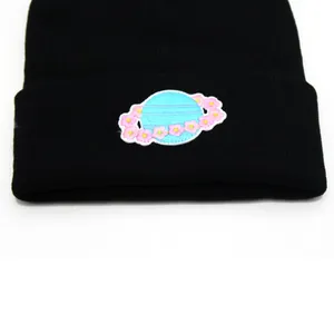 Winter knit beanie hat in black featuring an embroidered planet with pink flowers