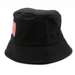 Close-up of black cotton bucket hat featuring red and white striped embroidery detail