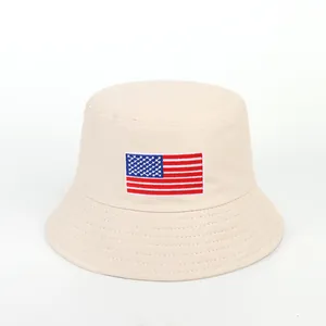 Detailed view of beige cotton bucket hat with American flag embroidery and stitched brim