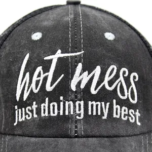 Washed black ponytail baseball cap with hot mess embroidery and criss-cross back