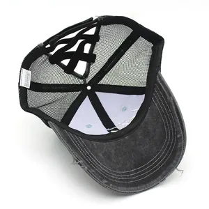 Detail of washed grey ponytail baseball cap showing criss-cross elastic bands and mesh back