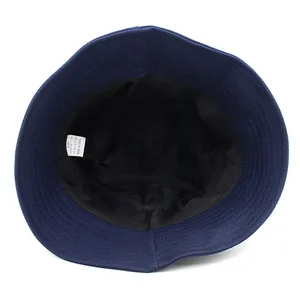 Inside view of a navy blue cotton bucket hat showing the sweatband and 100% cotton label