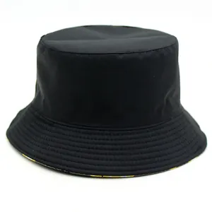 Reversible black bucket hat with lemon fruit print lining and reinforced stitching