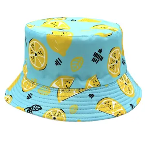 Reversible bucket hat with lemon print on light blue cotton fabric for sun protection