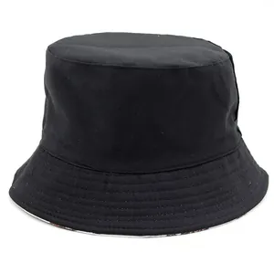 Double-sided reversible sun hat featuring black cotton exterior and colorful owl print